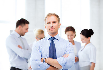 Image showing handsome businessman with team in office