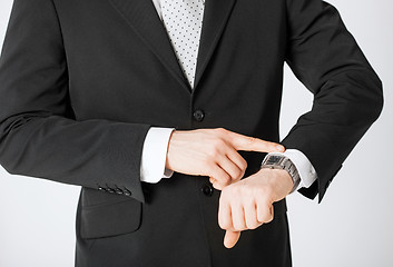 Image showing man looking at wristwatch