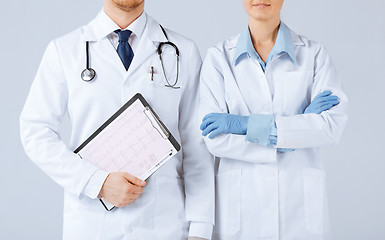 Image showing nurse and male doctor holding cardiogram