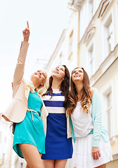 Image showing beautiful girls looking at something in the city