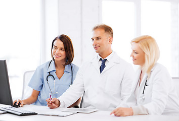 Image showing doctors looking at computer on meeting