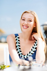 Image showing girl in cafe on the beach