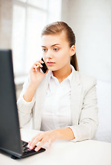 Image showing businesswoman with smartphone in office