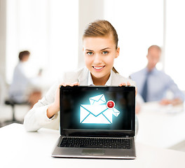 Image showing businesswoman holding laptop with email sign