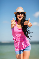 Image showing girl showing thumbs up on the beach