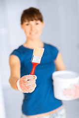 Image showing woman with paintbrush and paint pot