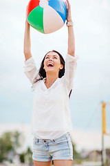 Image showing girl playing ball on the beach