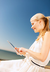 Image showing beautiful woman in a dress with tablet pc