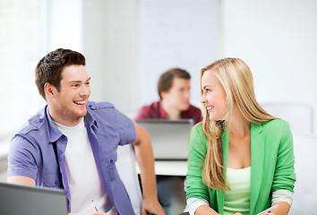 Image showing smiling students looking at each other at school