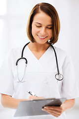 Image showing female doctor with stethoscope and clipboard