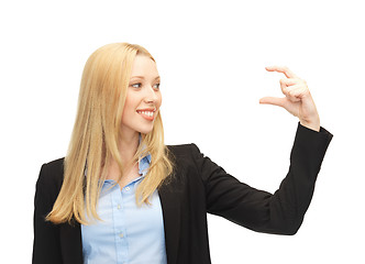 Image showing businesswoman holding something imaginary