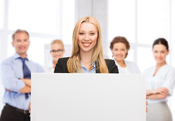 Image showing businesswoman with white blank board