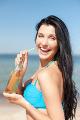 Image showing girl with bottle of drink on the beach