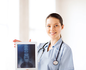 Image showing female doctor with x-ray on tablet pc