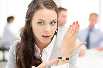 Image showing businesswoman pointing at her watch