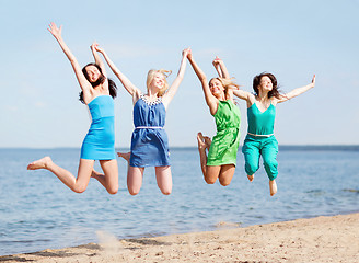 Image showing girls jumping on the beach