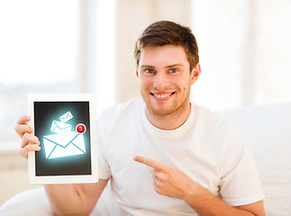 Image showing man holding tablet pc with email sign at home