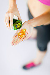 Image showing woman hand with capsules