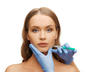 Image showing woman face and beautician hands with syringe