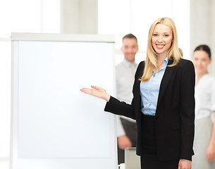 Image showing businesswoman with flipchart in office