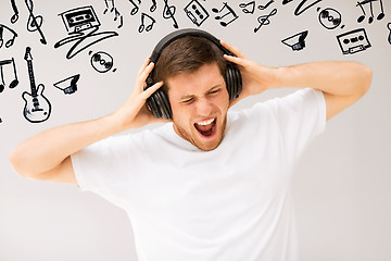 Image showing man with headphones listening loud music