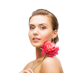 Image showing woman with diamond earrings and flower