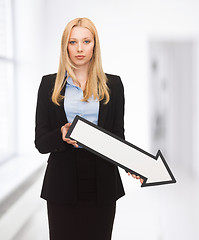 Image showing businesswoman with direction arrow sign