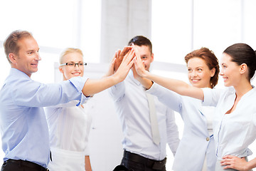 Image showing business team celebrating victory in office