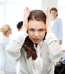 Image showing stressed businesswoman in office