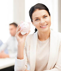 Image showing woman with piggy bank