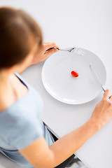 Image showing woman with plate and one tomato