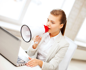 Image showing strict businesswoman shouting in megaphone