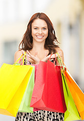 Image showing woman holding color shopping bags in mall