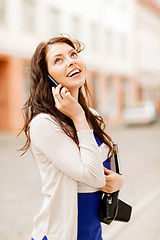 Image showing girl with phone, tourist book and vintage camera