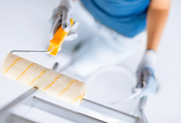 Image showing woman with roller and paint pot