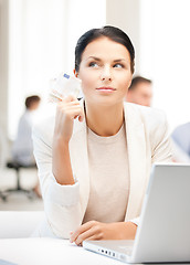 Image showing pensive businesswoman with cash money