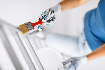 Image showing woman with paintbrush and paint pot