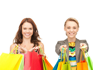 Image showing attractive girls holding color shopping bags