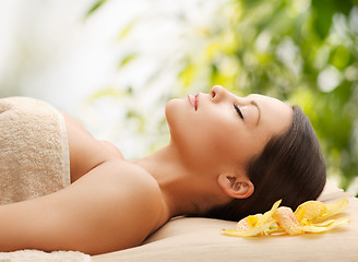 Image showing woman in spa lying on the massage desk