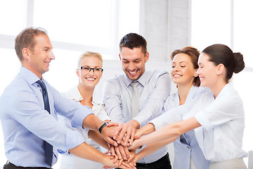 Image showing business team celebrating victory in office