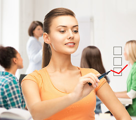 Image showing student drawing checkmark on virtual screen