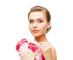 Image showing woman wearing earrings and ring with flowers