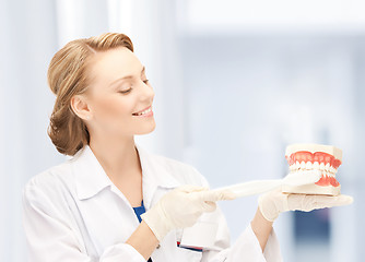 Image showing doctor with toothbrush and jaws in hospital