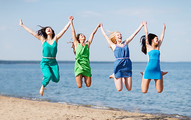 Image showing girls jumping on the beach