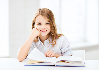 Image showing little student girl studying at school