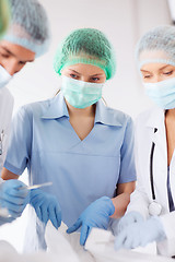 Image showing young group of doctors doing operation