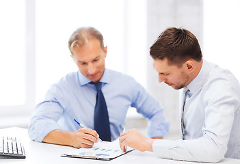 Image showing businessmen with notebook on meeting