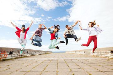 Image showing group of teenagers jumping