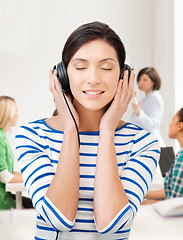 Image showing student girl in big headphones at school