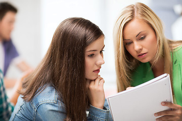 Image showing student girls looking at notebook at school